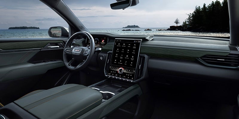 Interior view of a 2024 GMC Acadia showcasing luxurious seating and modern dashboard design.